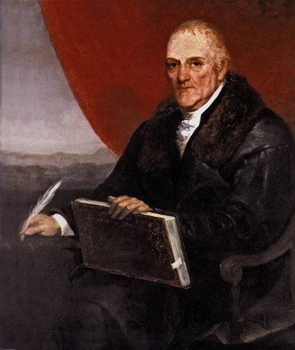 Portrait von Laurenzo da Ponte in einem schwarzen Mantel sitzend mit einem großen Buch, das geschlossen auf seinem Schoß liegt und einer Schreibfeder in der rechten Hand.