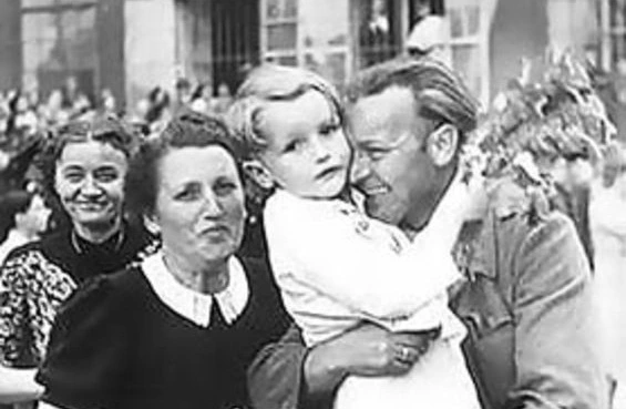 Nicht immer gibt es so ein freudiges Wiedersehen. Der Vater wird am Bahnhof begrüßt. Wien um 1947. Soldat in Uniform nimmt den jungen Sohn in den Arm. Die Mutter steht freudig daneben. 