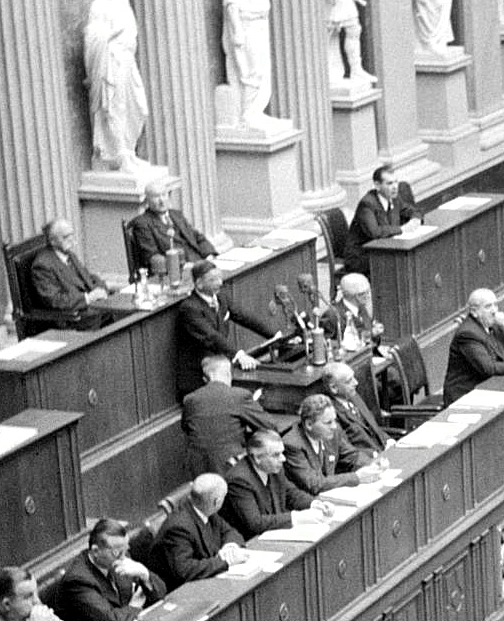 Blick in den Reichsratssitzungssaal des Parlaments. Zoom auf Leopold Figl am Rednerpult.