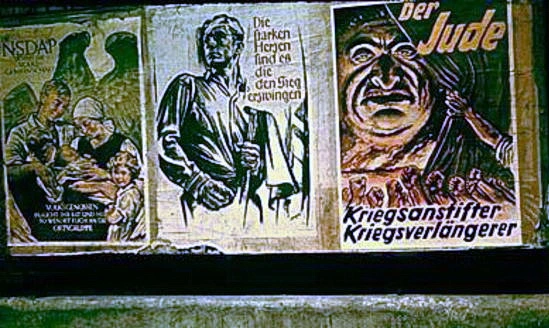 Drei Plakate in Wien, um 1941. (1) "NSDAP sichert die Volksgemeinschaft  –  Volksgenossen braucht ihr Rat und Hilfe, so wendet euch an die Ortsgruppe". (2) "Die starken Herzen sind es, die den Sieg erzwingen". (3) "Der Jude. Kriegsanstifter. Kriegsverlängerer".