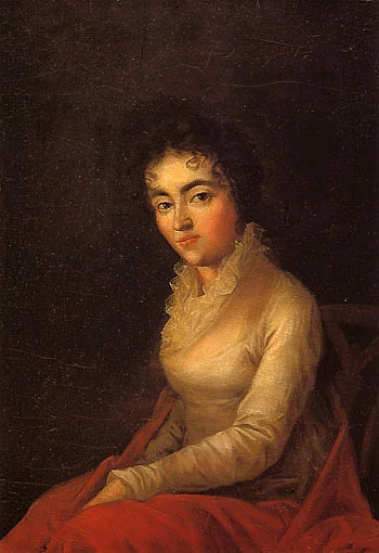 Portrait der seitlich sitzenden Constanze Weber, die den Maler direkt mit dunklen Augen anblickt. Schwarze Locken hängen ihr in die Stirn und die Hände liegen auf ihrem Schoß.